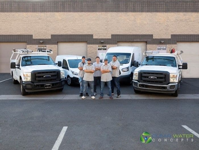 Clear Water Concepts team standing in front of service vehicles in Arizona