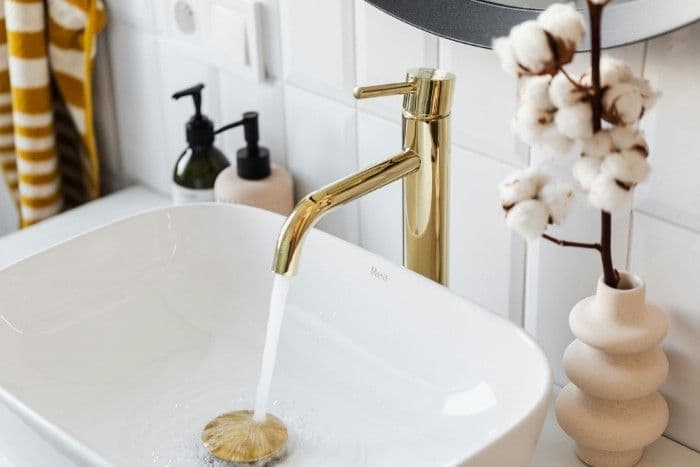 Reduced scale bathroom faucet after salt-free water conditioning system installation in Phoenix