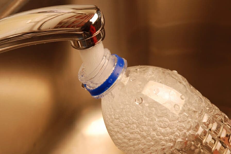 hard tap water filling bottle from faucet