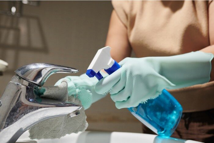 Cleaning mineral deposit stains off a bathroom faucet caused by hard water