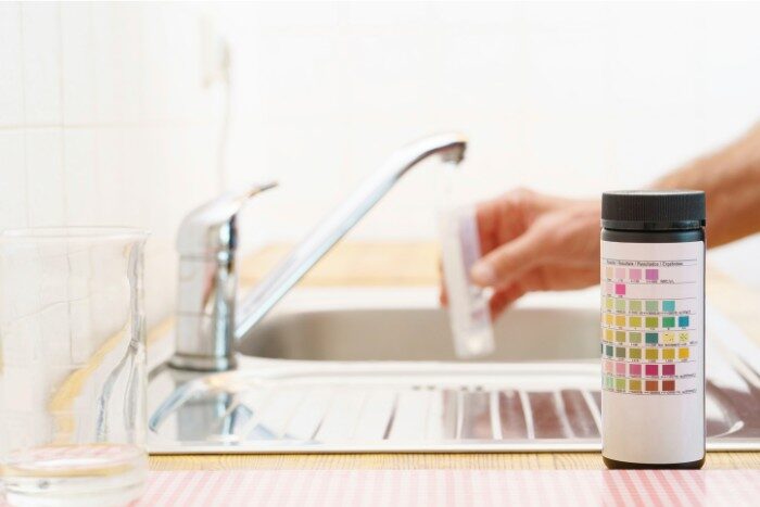 Homeowner checking water quality to evaluate softener performance