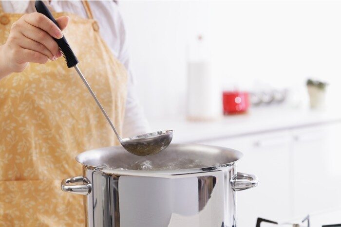 Person using purified water for cooking in a kitchen