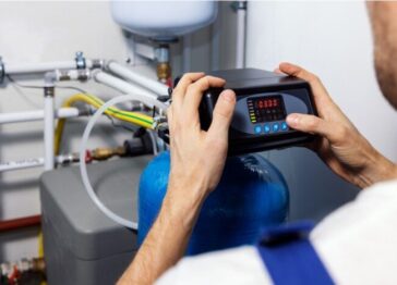 Technician programming a whole-house water softener system