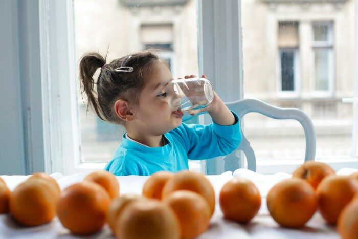 Child enjoying clean filtered drinking water for better health and hydration