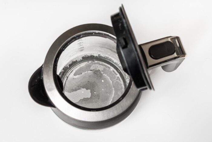 Mineral deposits from hard water visible inside a household kettle