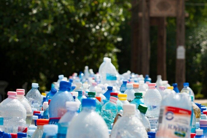 Large collection of empty plastic water bottles highlighting waste from bottled water use