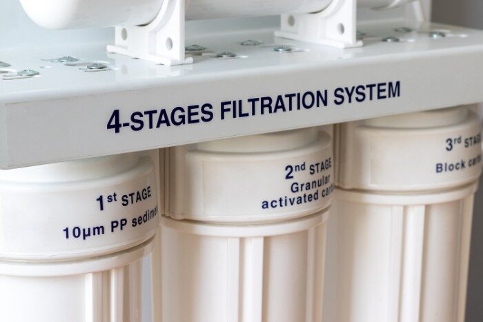 Multi-stage water filtration system showing sediment and carbon filter stages