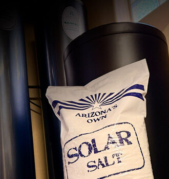 Pouring fresh salt into the water softener system during routine maintenance