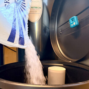 Water Softener system maintenance showing how salt refills protect against Arizona hard water