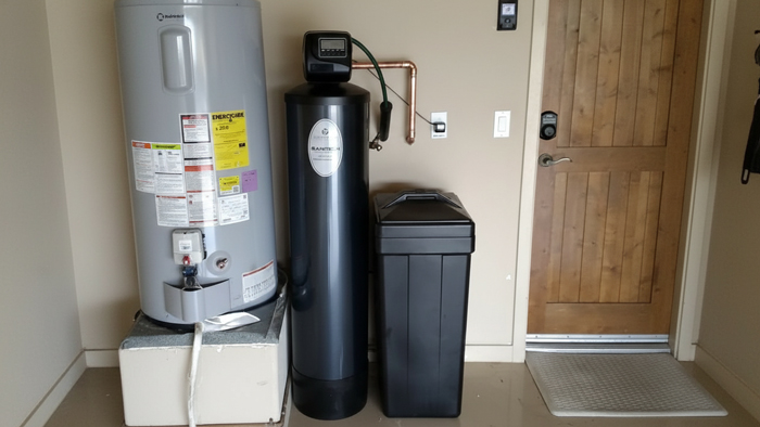 Water softener system with brine tank installed in a home utility space