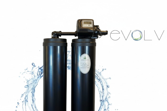 Control valve and resin tank component of a water softener system