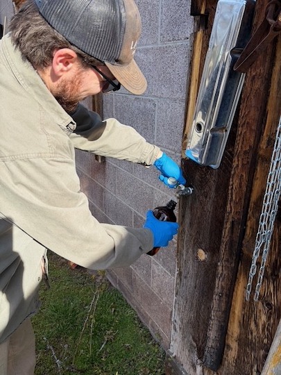 Technician taking a water sample for Arizona drinking water contaminant testing