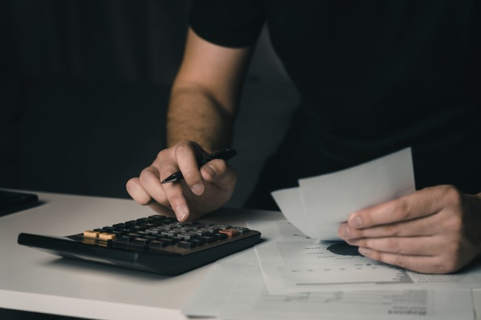 Business owner reviewing cost estimates for commercial water softener equipment