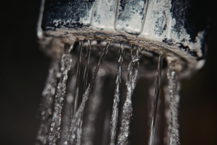 Chalky deposits on showerhead showing signs of permanent water hardness