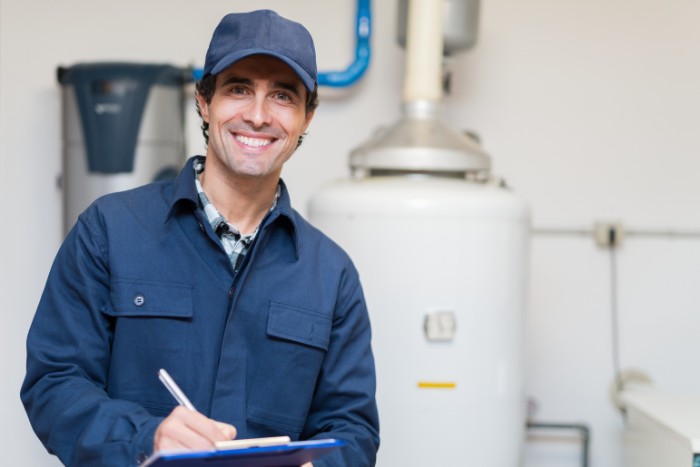 Arizona water heater technician performing a maintenance inspection