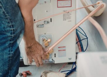 Technician servicing water heater during maintenance